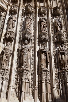 Spain, Andalucia, Seville, Carved figures on theCathedral Door of the Assumption.