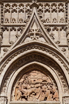 Spain, Andalucia, Seville, Engraving on the arch to Door of the Bells depicting Christ's entry into Jerusalem on a donkey of Seville Cathedral.