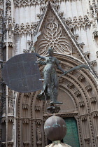 Spain, Andalucia, Seville, A replica of the Giraldillo weathervane statue of faith in front of the south door of Seville Cathedral.