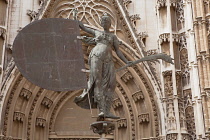 Spain, Andalucia, Seville, A replica of the Giraldillo weathervane statue of faith in front of the south door of Seville Cathedral.