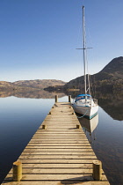 England, Cumbria, Lake District, Glenridding, Yacht moored at a jetty on Lake Ullswater.