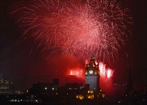 Scotland, Edinburgh, Fireworks for the closing of the Festival & Military Tattoo, view from Calton Hill across to the Castle with the clocktower & Balmoral Hotel.