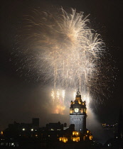 Scotland, Edinburgh, Fireworks for the closing of the Festival & Military Tattoo, view from Calton Hill across to the Castle with the clocktower & Balmoral Hotel.