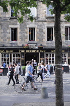 Scotland, Edinburgh, Grassmarket, street scene looking across Grassmarket pedestrian area to the Beehive Pub with cyclist & pedestrians..