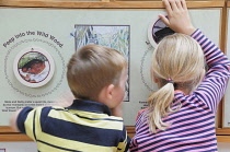 Scotland, Edinburgh, Scottish Storytelling Centre at John Knox house, story wall with children exploring it..