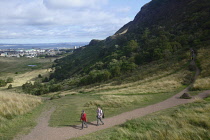 Scotland, Edinburgh, Holyrood Park, walkers and views toward the city.
