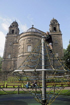 Scotland, Edinburgh, Princes Street gardens, play area climbing frame with St Cuthbert's church, West Princes Street gardens.