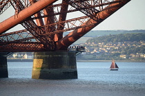 Scotland, Edinburgh, Forth Rail Bridge, South Queensferry, bridge detail with sailing boat showing scale.