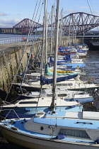 Scotland, Edinburgh, South Queensferry, harbour with boats & Forth Road Bridge in distance.
