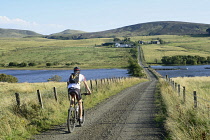 Scotland, Edinburgh, Pentland Hills, Threipmuir Reservoir, cyclist on path to Reservoir.