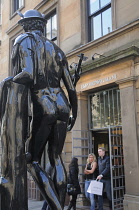 Scotland, Glasgow, Merchant City, the Italian Centre, statue of Mercury outside Armani store with shoppers.