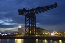 Scotland, Glasgow,  the Clyde, Finnieston Crane & riverside at night.