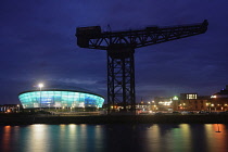 Scotland, Glasgow, The Clyde, The Hydro arena lit at night with Finnieston crane.