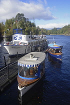 Scotland, Loch Lomond, Loch Katrine, boats at pier side.