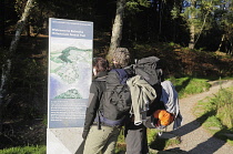 Scotland, Loch Lomond, Balmaha, West Highland Way, hikers and signage.