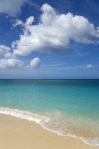 West Indies Caribbean Grenada St George Parish Waves breaking on the shore at Grand Anse Beach with the turquoise sea beyond