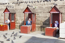 Turkey, Istanbul, People selling food for pigeons at the New Mosque, Eminonu Yeni Camii, Eminonu.