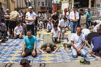 Turkey, Istanbul, Muslims praying during Friday prayers in a street near Taksim Square.