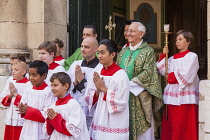 France, Saint Tropez, Choir boys and priest outside Notre Dame de L'Assomption Church.