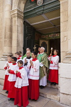France, Saint Tropez, Choir boys and priest outside Notre Dame de L'Assomption Church.