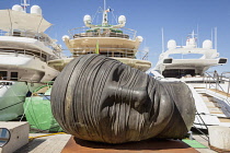 France, Saint Tropez, Testa Addormentata 1983 sculpture by Igor Mitoraj on the quayside.