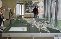 Germany, Lower Saxony, Bergen Belsen, Tourists looking at exhibits.