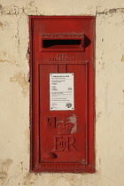 Malta, Qawra, British ER red post box in wall.