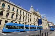 Croatia, Zagreb, Old town, Mihanoviceva Street, Hz Vuca Vlakova national railway headquarters with tram apssing by.