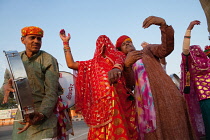 India, Rajasthan, Bikaner, Rajasthani musical troupe and dancers celebrate the festival of Holi.