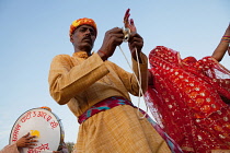 India, Rajasthan, Bikaner, Rajasthani musical troupe and dancers celebrate the festival of Holi.