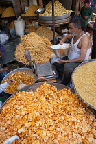 India, Rajasthan, Bikaner, Vendor selling namkeen, chat and savoury snacks in the market at Bikaner.