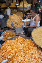 India, Rajasthan, Bikaner, Vendor selling namkeen, chat and savoury snacks in the market at Bikaner.