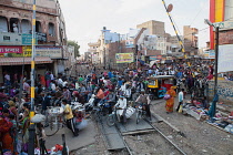 India, Rajasthan, Bikaner, Pedestrians and traffice at a railway level crossing in Bikaner.