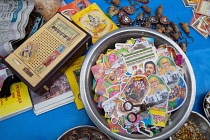 India, Rajasthan, Pushkar, Market stall in Pushkar bazaar selling trinkets and religious images, the vendor's transitor radio is amongst the wares, .