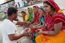 India, Rajasthan, Pushkar, A pandit conducts a puja on the ghats of Pushkar Lake.
