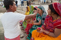 India, Rajasthan, Pushkar, A pandit conducts a puja on the ghats of Pushkar Lake.