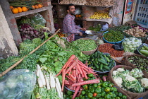 India, Rajasthan, Pushkar, Grocer selling vegetables in the market at Pushkar.