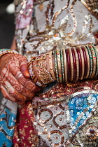 India, Rajasthan, Kekri, Detail of jewellery, bangles and henna tattoo on a Rajasthani tribal woman.