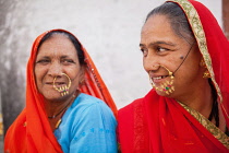 India, Rajasthan, Kekri, Rajasthani tribal women with nasal jewellry.