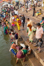India, Uttar Pradesh, Varanasi, Pilgrims on the ghats beside the Ganges at Varanasi.