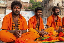 India, Uttar Pradesh, Varanasi, Pilgrims pray on the ghats beside the Ganges at Varanasi.
