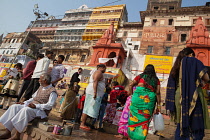 India, Uttar Pradesh, Varanasi, Pilgrims on the ghats beside the Ganges at Varanasi.