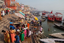India, Uttar Pradesh, Varanasi, Pilgrims on the ghats beside the Ganges at Varanasi.