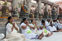 India, Bihar, Bodhgaya, Pilgrims praying at the Mahabodhi Temple in Bodhgaya.