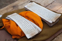 India, Bihar, Bodhgaya, Prayer cards on a saffron robe at the Mahabodhi Temple in Bodhgaya.
