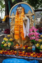 India, Bihar, Bodhgaya, An image of the Buddha wrapped in a khata, ceremonial scarf, at the Mahabodhi Temple in Bodhgaya.
