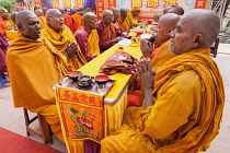 India, Bihar, Bodhgaya, Monks praying at the Mahabodhi Temple in Bodhgaya.