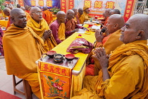 India, Bihar, Bodhgaya, Monks praying at the Mahabodhi Temple in Bodhgaya.