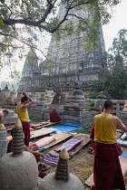 India, Bihar, Bodhgaya, Buddhist monks praying and prostrating themselves at the Mahabodhi Temple in Bodhgaya.