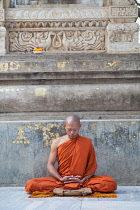 India, Bihar, Bodhgaya, A Buddhist Monk in meditation at the Mahabodhi Temple in Bodhgaya.